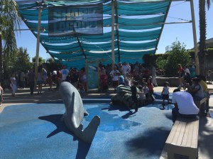 KIDS and their parents take a break in the shade at the aquarium's Shark Lagoon. (Jim Burns)